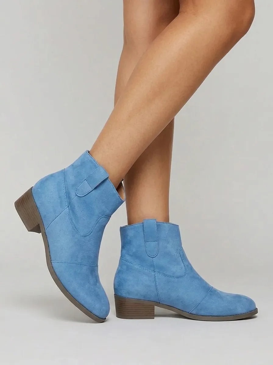 Side view of blue Western ankle boots showing the ankle-height profile, rounded toes, pull tabs, and low heels.