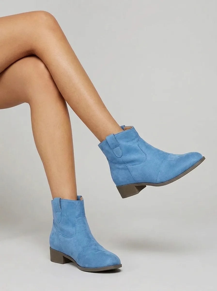 Blue Western ankle boots displayed at an angle, with one boot lifted to show the low heel and rounded toe.