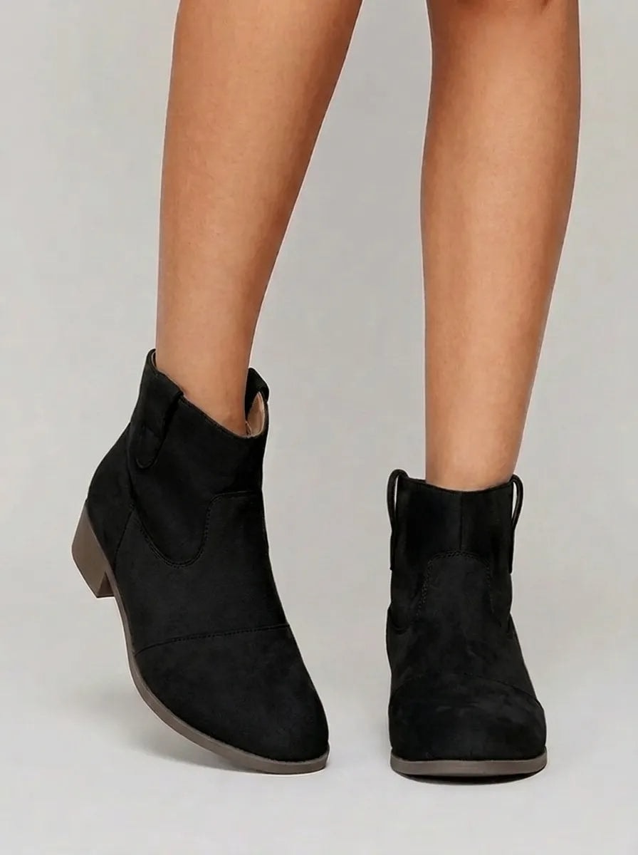 Black Western ankle boots with rounded toes, side pull tabs, decorative stitching, and low block heels.