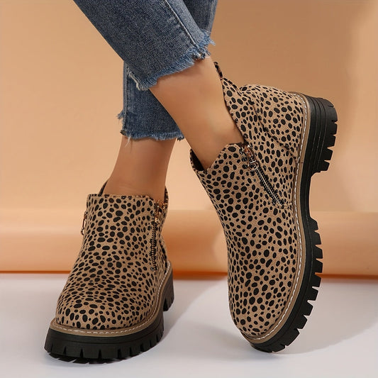 Leopard-print ankle boots shown on feet, highlighting the chunky lug soles and contrasting stitching.