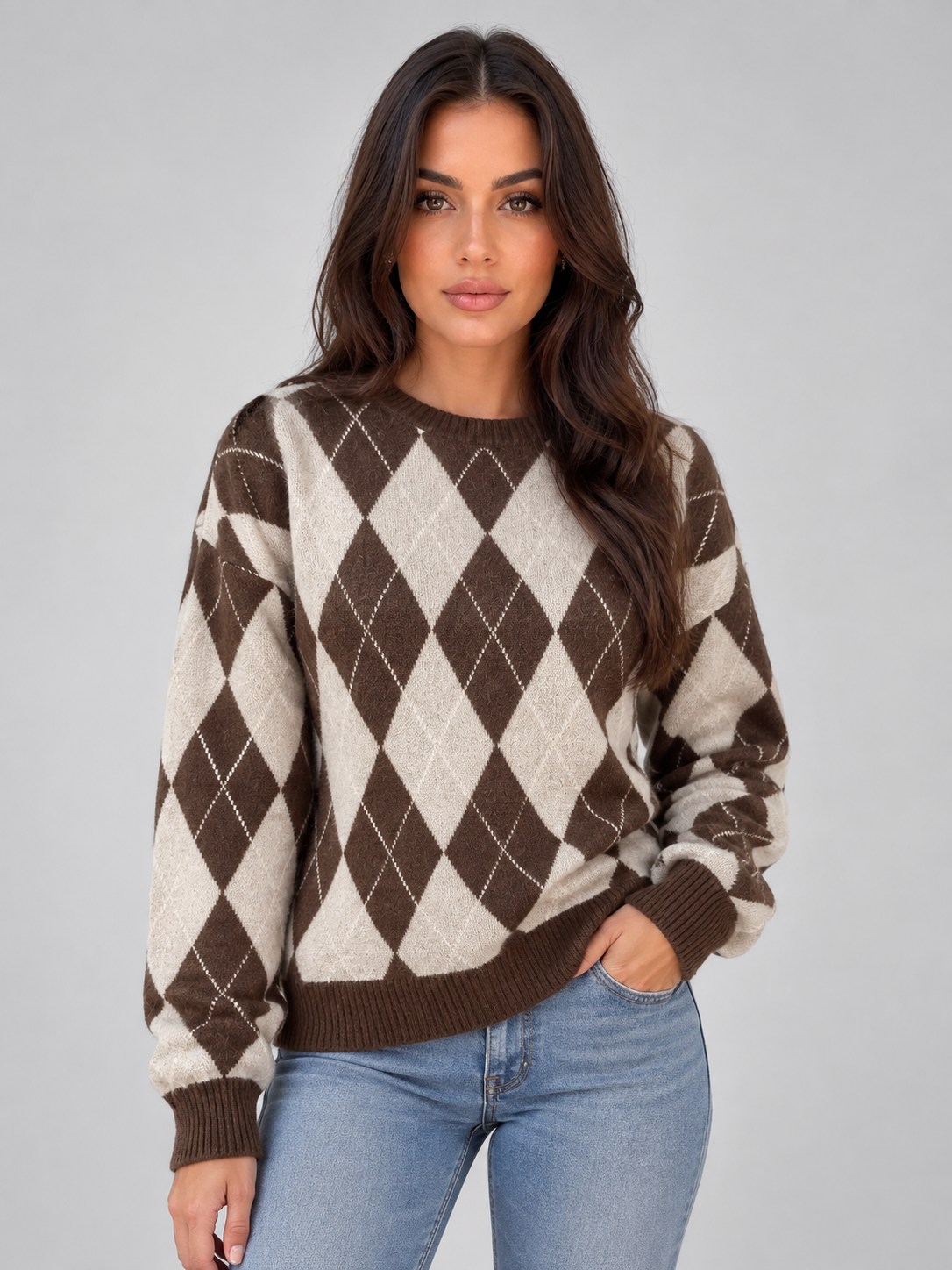 Front view of a brown and cream argyle crew neck jumper with long sleeves, ribbed cuffs and hem, styled with jeans.