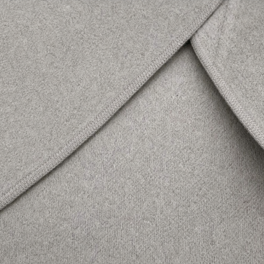 Close-up of the jacket’s finished edge stitching along the overlapping wrap panel.