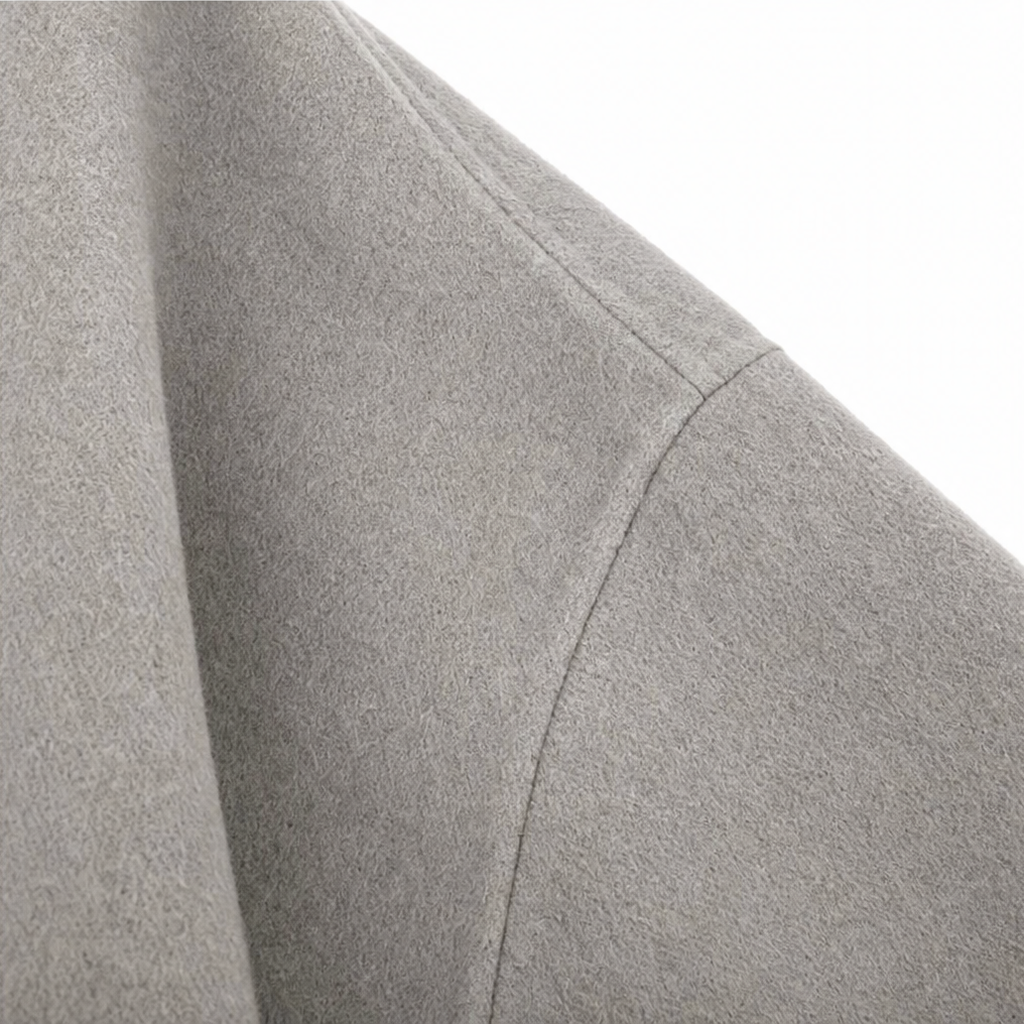 Detail of the jacket’s wide sleeve and visible seam near the upper arm.