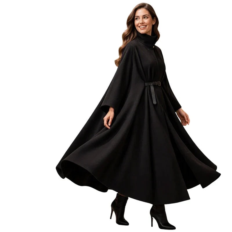 Black cape coat on a plain background, shown in a full flowing silhouette with a high collar, belt, and flared hem.