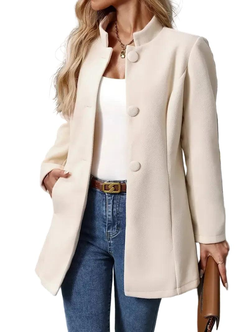 Cream longline coat shown partially fastened, highlighting its round collarless neckline, front buttons, long sleeves, and side pocket.