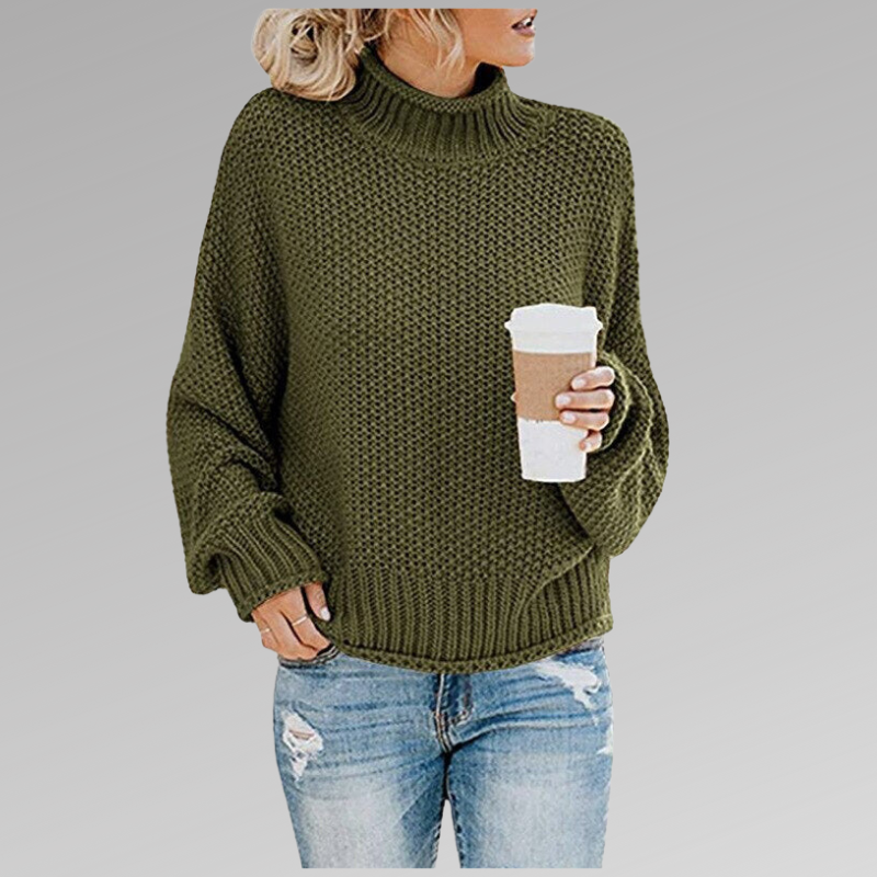 Olive green chunky knit turtleneck sweater with a relaxed fit, ribbed trim and long sleeves, shown with jeans.