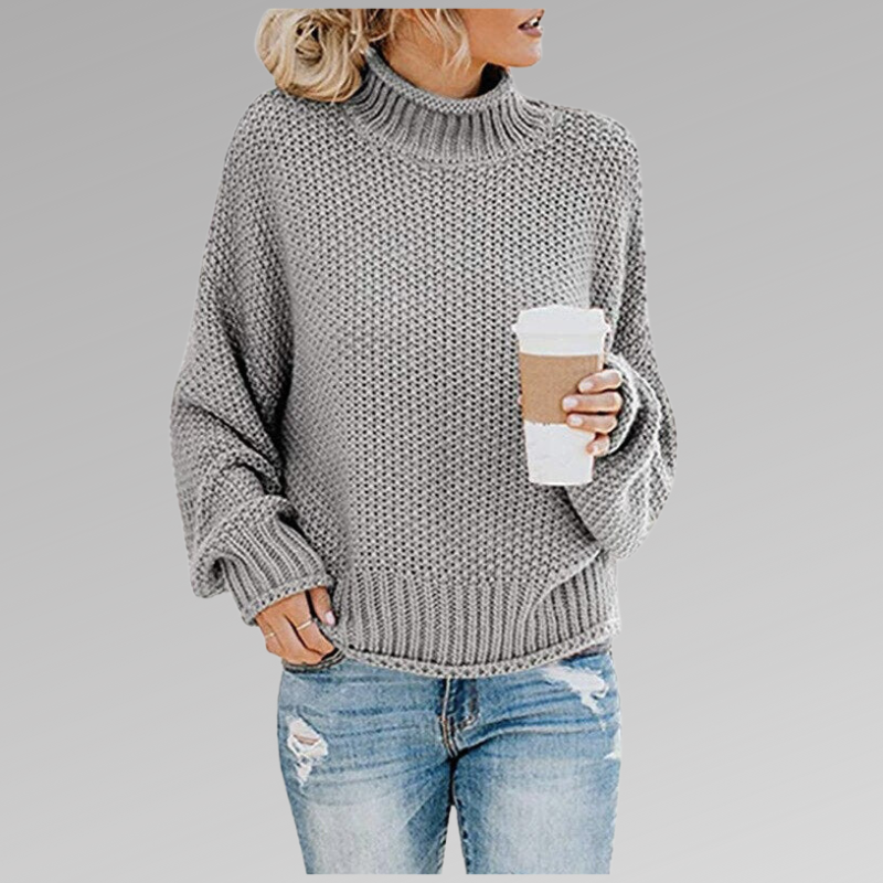 Light gray chunky knit turtleneck sweater with a high ribbed collar, relaxed silhouette and ribbed hem.