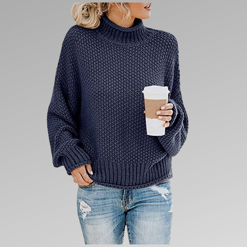 Navy chunky knit sweater with a ribbed turtleneck, roomy long sleeves and a structured ribbed hem.