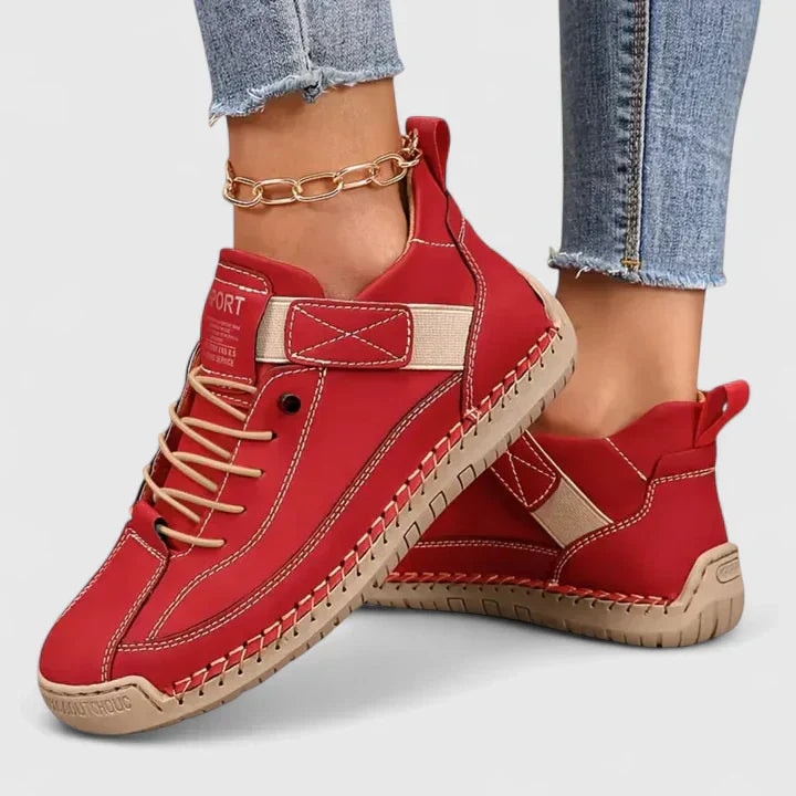 Red casual sneakers with contrasting ankle straps, laces, rounded toes, and textured outsoles.