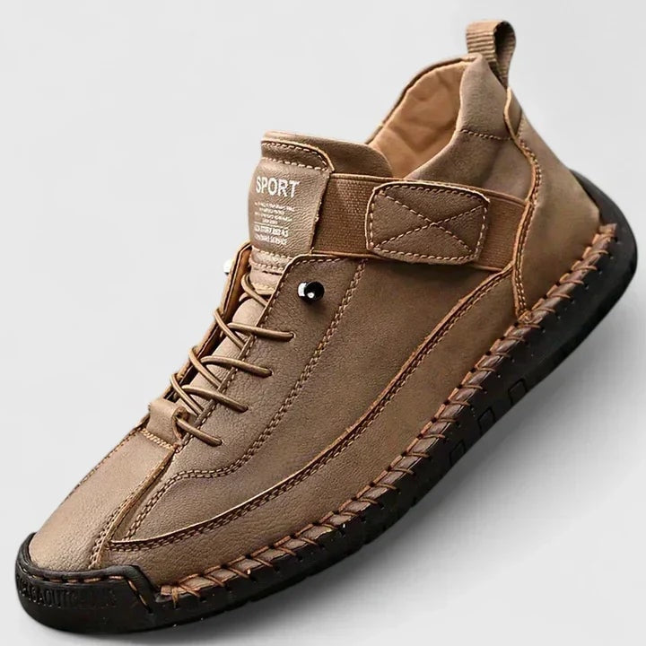 Single brown sneaker shown close up to highlight its laces, adjustable strap, rounded toe, and textured outsole.