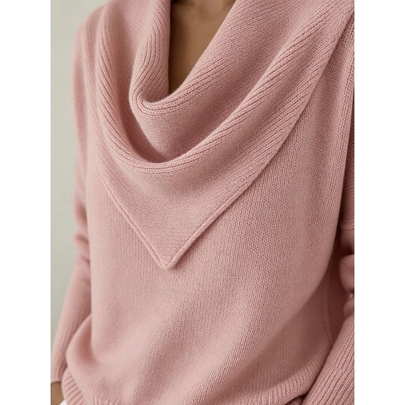 Close-up of the pink sweater's layered draped cowl neckline and pointed front detail.