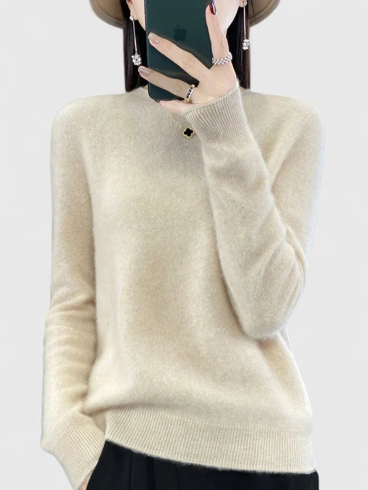 Cream crew neck sweater against a plain background, featuring long sleeves, ribbed cuffs, and a ribbed hem.