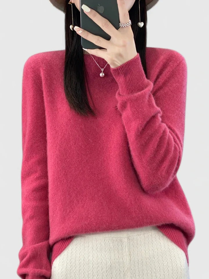 Berry pink crew neck sweater against a plain background, with a relaxed silhouette and ribbed cuffs.