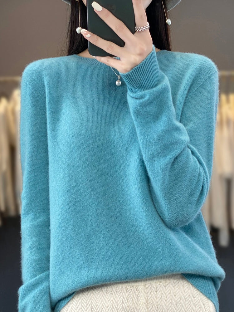 Light turquoise crew neck sweater shown with a softly relaxed fit and gathered ribbed cuffs.