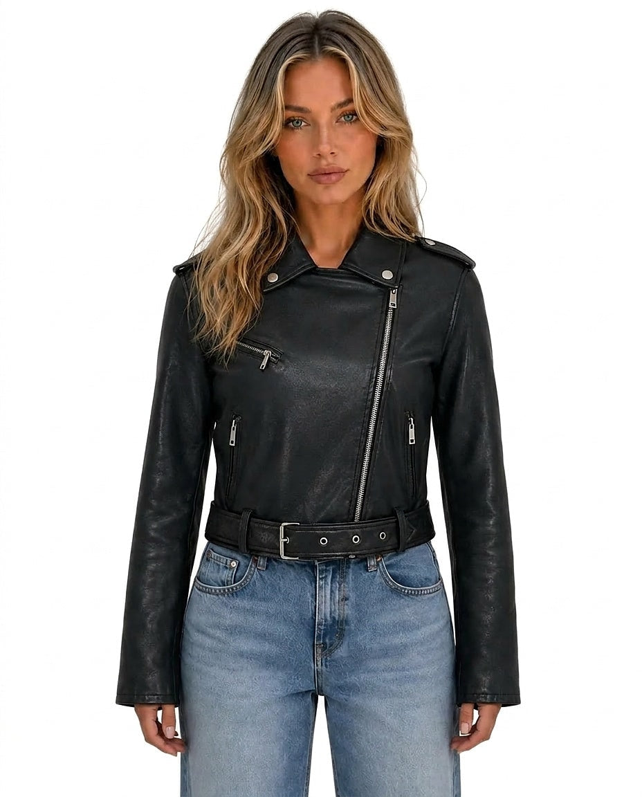 Front view of a black cropped biker jacket with an asymmetrical zip, notched lapels, shoulder epaulettes, belted waist, and zip pockets, styled with jeans.