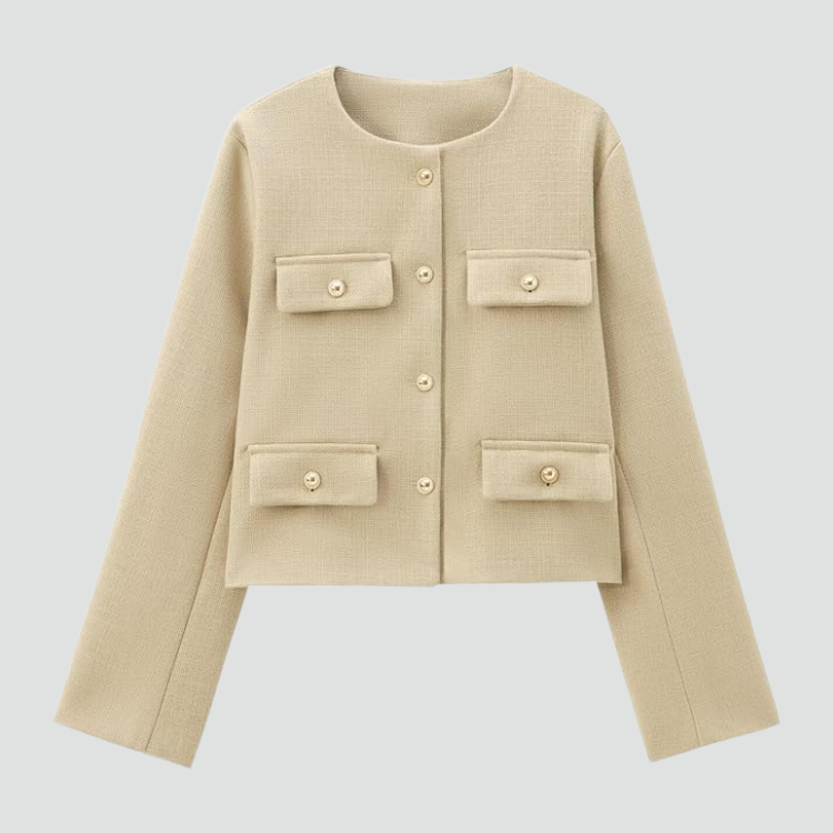 Flat lay of the cream cropped collarless blazer showing its round neckline, long sleeves, gold-tone buttons, and four flap pockets.