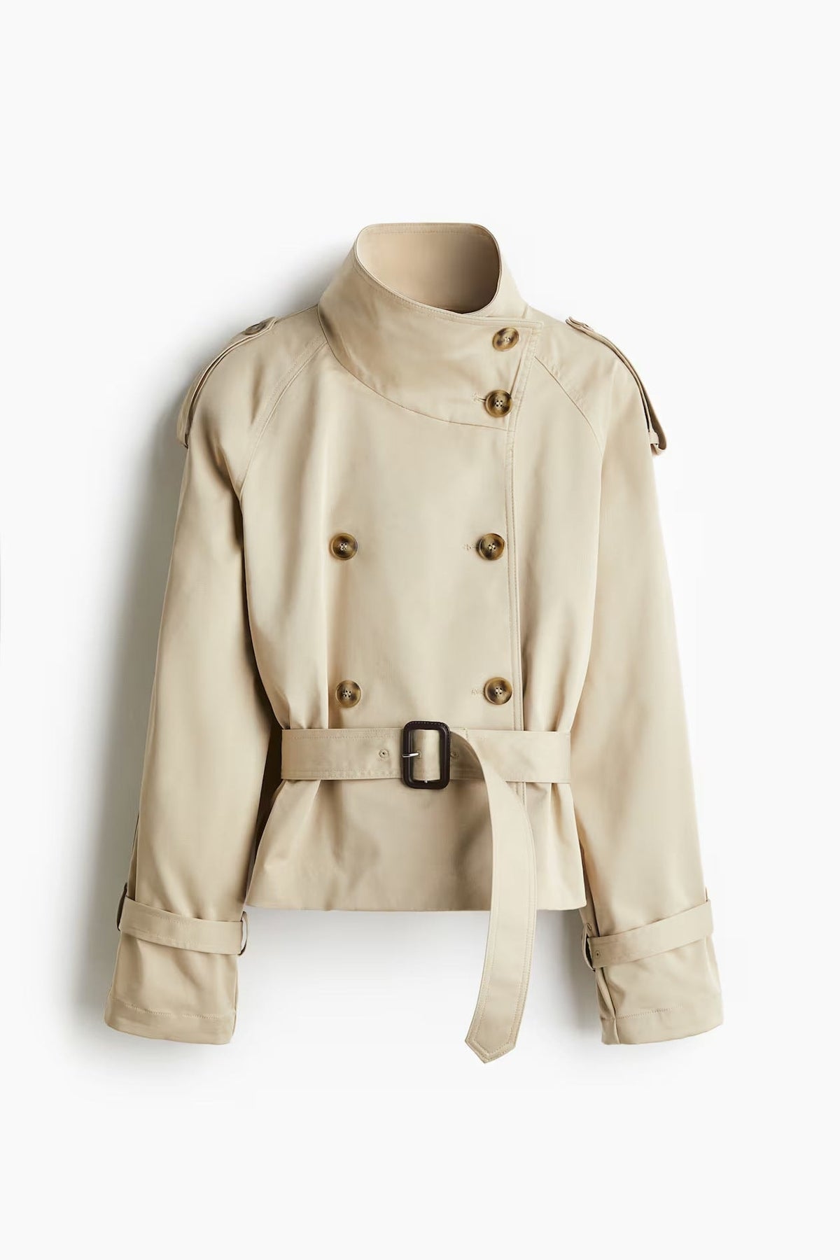 Front view of the cropped beige double-breasted trench coat with stand collar, belted waist, shoulder epaulettes, and cuff straps.