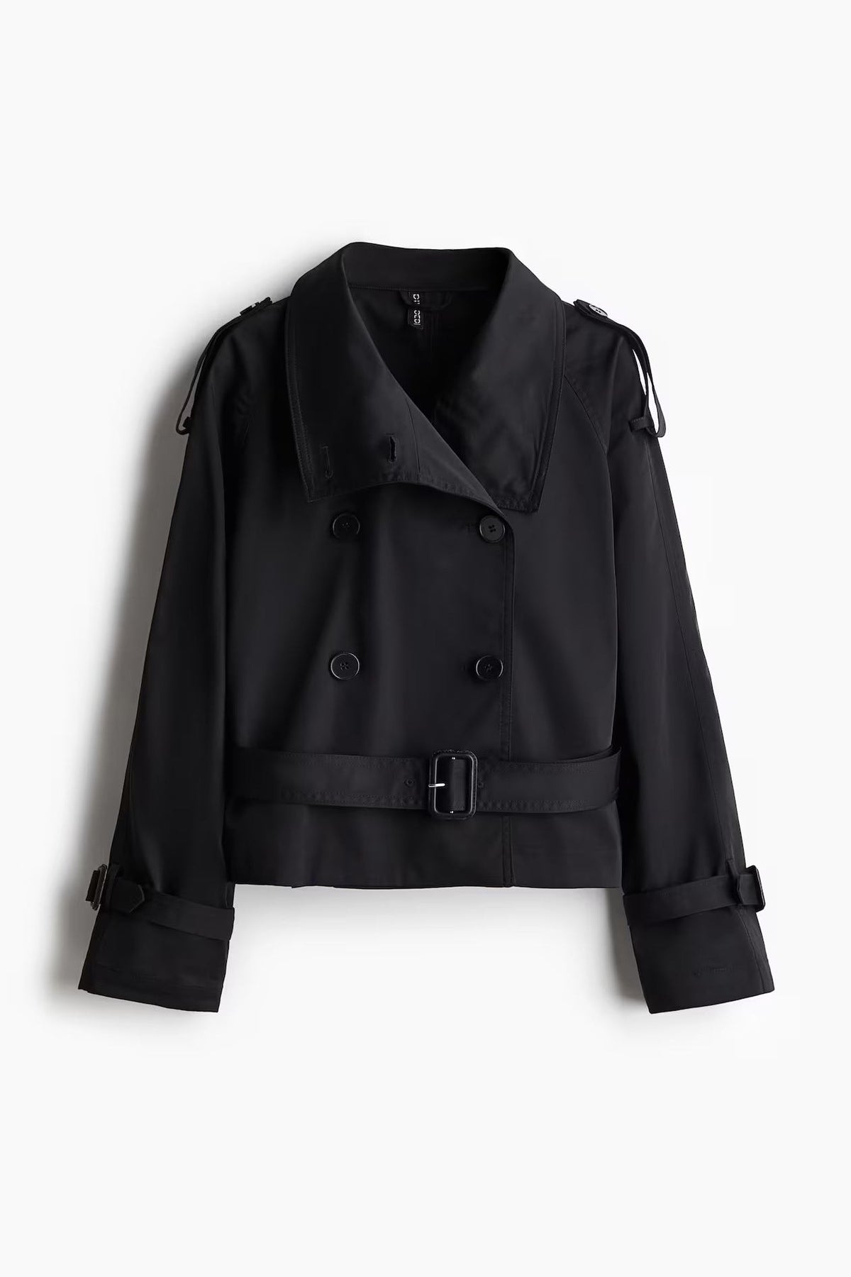 Front view of the black cropped trench coat with a double-breasted button front, belted waist, shoulder epaulettes, and cuff straps.