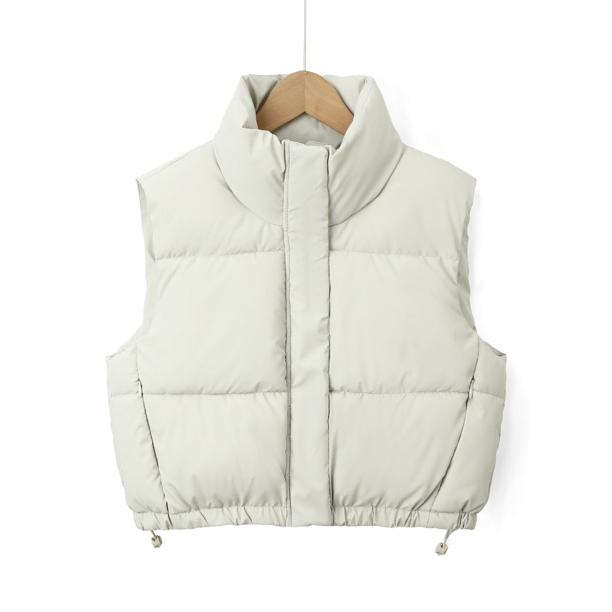 Close front view of the off-white puffer vest highlighting the high collar, central zip placket, and hem toggles.