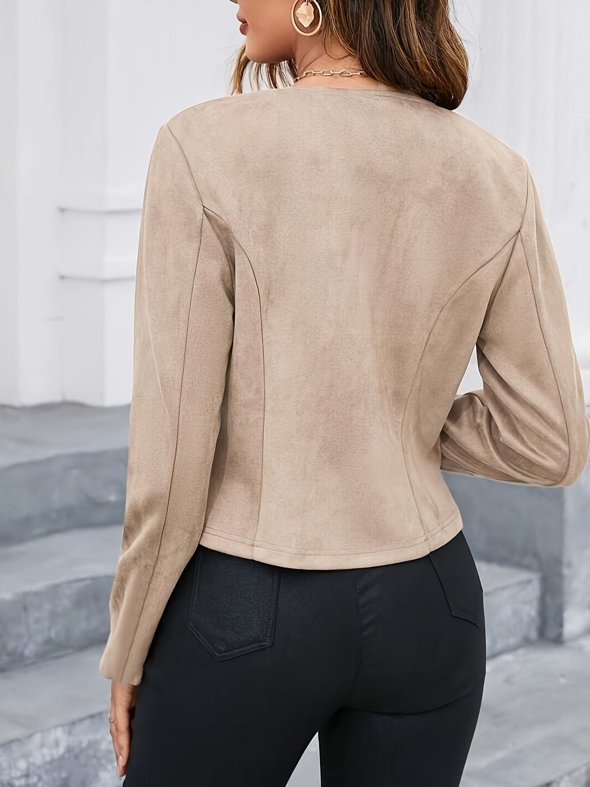 Back view of a taupe cropped tailored jacket showing long sleeves, a fitted waist, and shaped back seams.