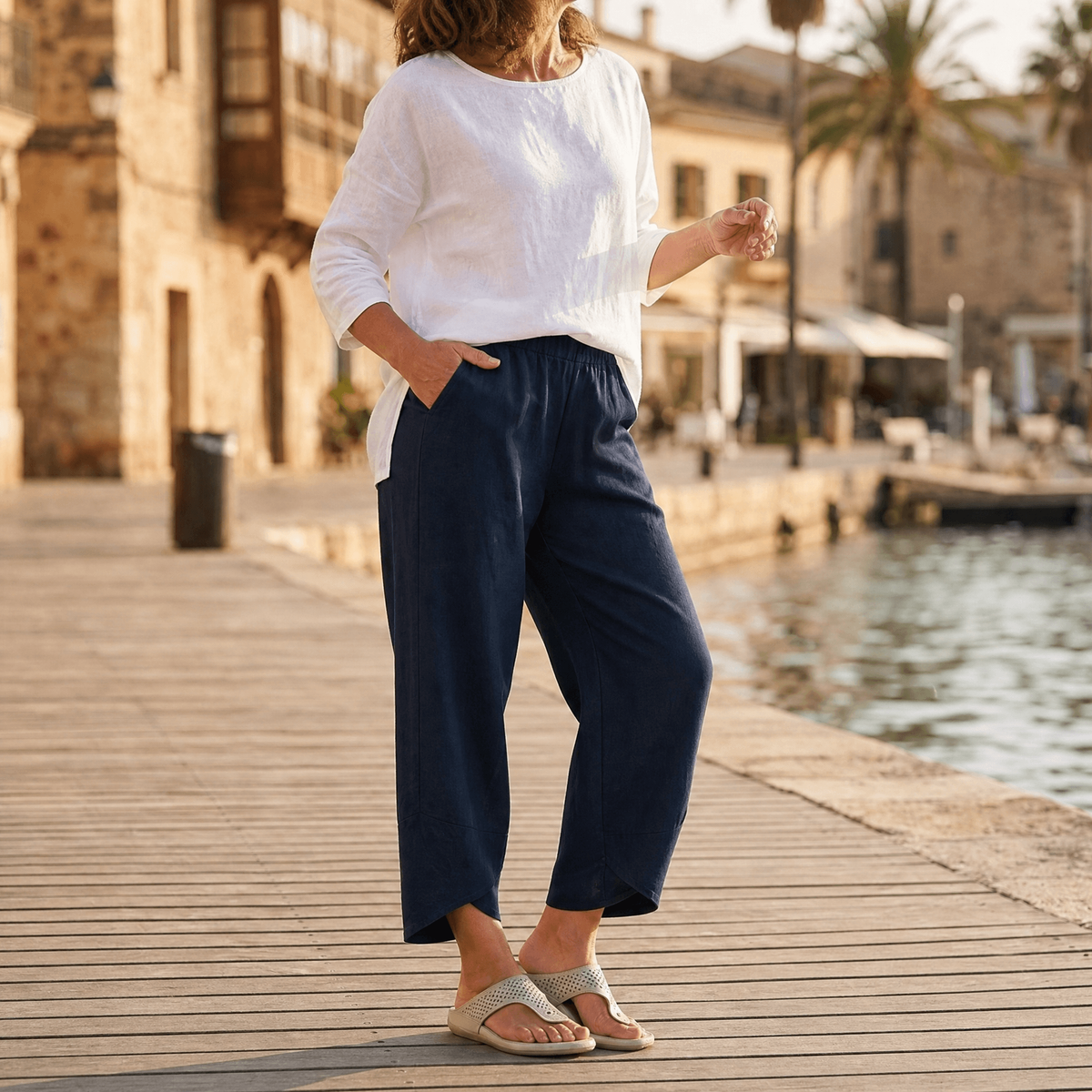 Front view of navy cropped wide-leg pants with a pull-on elastic waistband and side pockets.