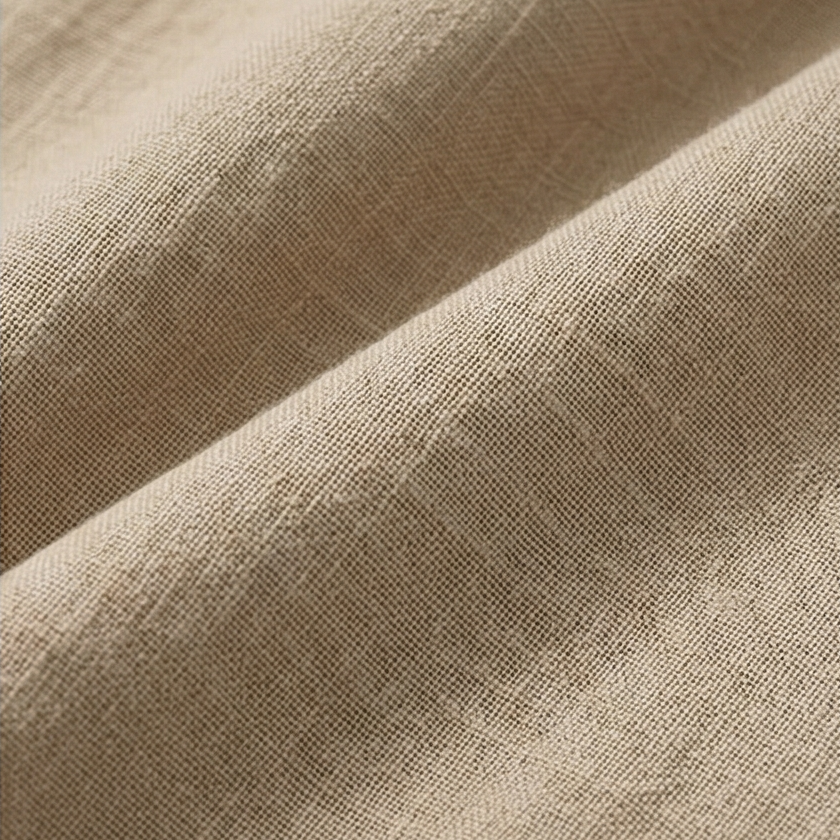 Close-up view highlighting the fine woven surface and soft beige color of the pants.