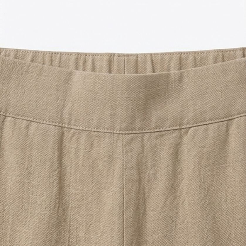 Close-up of the pants' elastic waistband and stitched upper front panel.