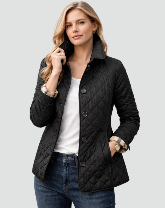 Black diamond-quilted button-front jacket with a raised shirt collar, long sleeves, and two side pockets, styled over a white top and jeans.