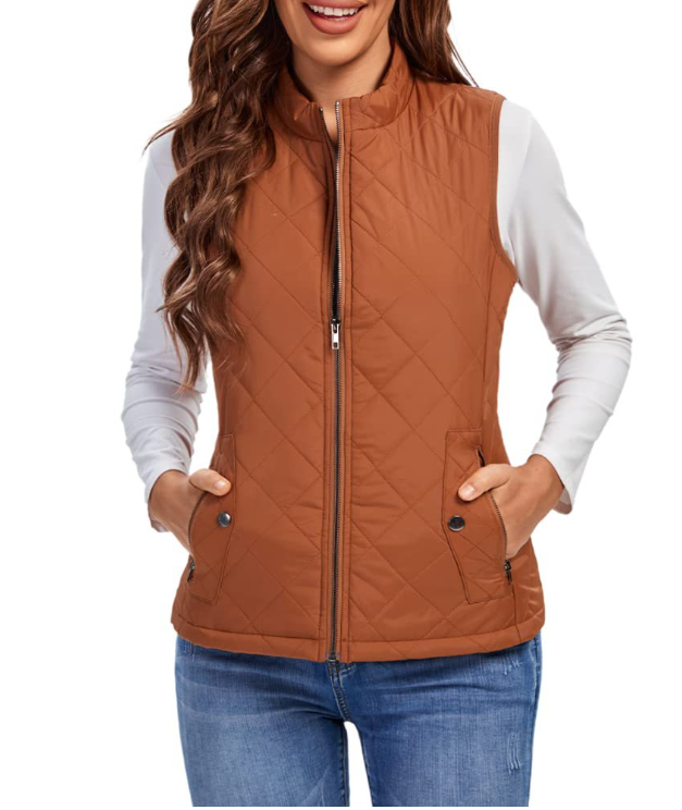 Brown sleeveless quilted vest shown from a slightly wider view, with a stand collar, front zipper, and hands resting in the pockets.