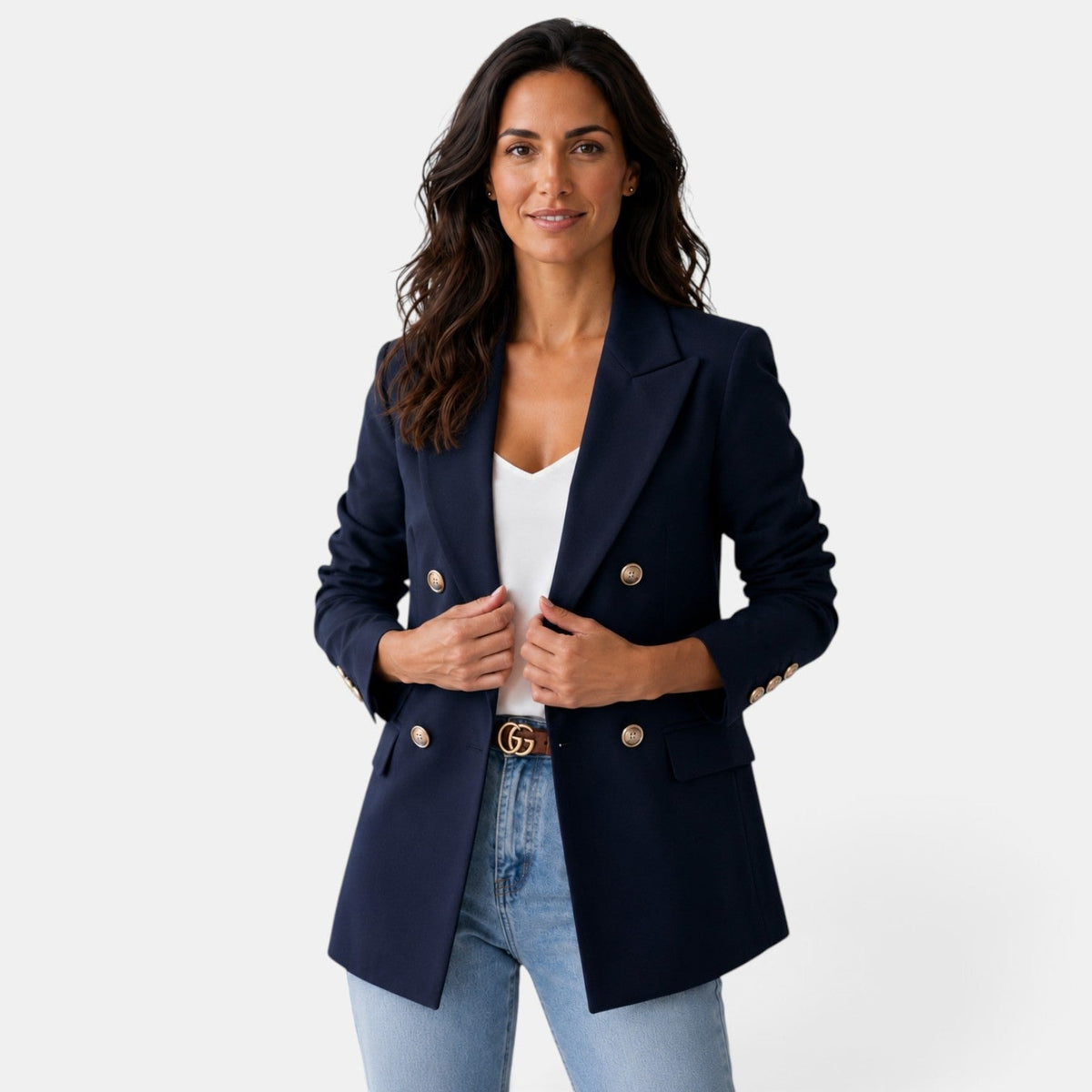 Front view of a navy double-breasted blazer with notch lapels, four buttons, long ruched sleeves, and flap pockets.