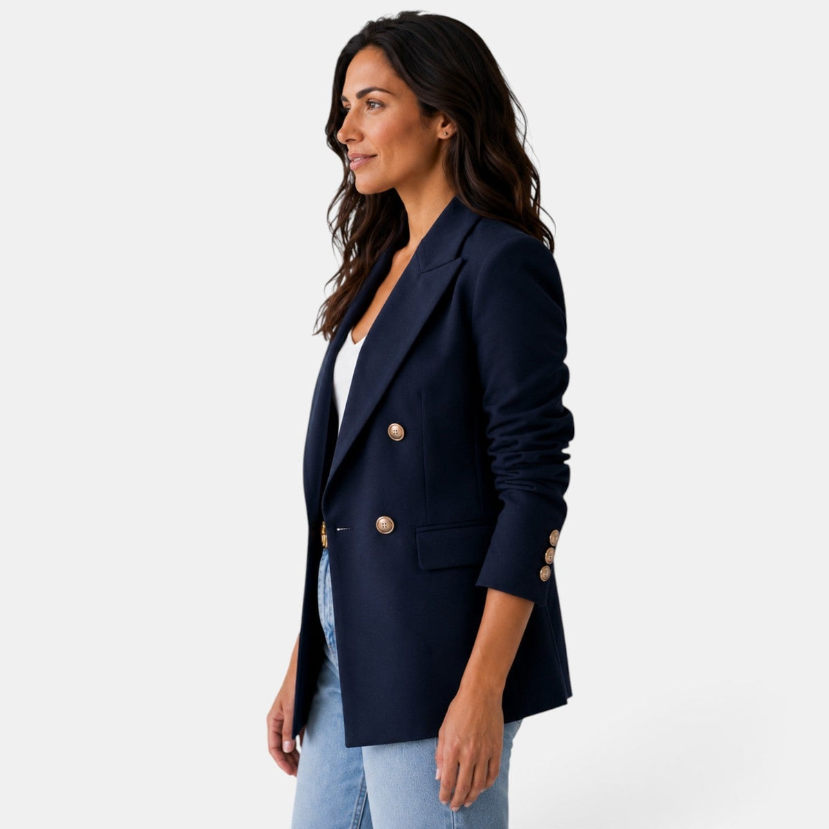 Side front view of the navy blazer emphasizing its tailored profile, notch lapel, flap pocket, and buttoned cuff.