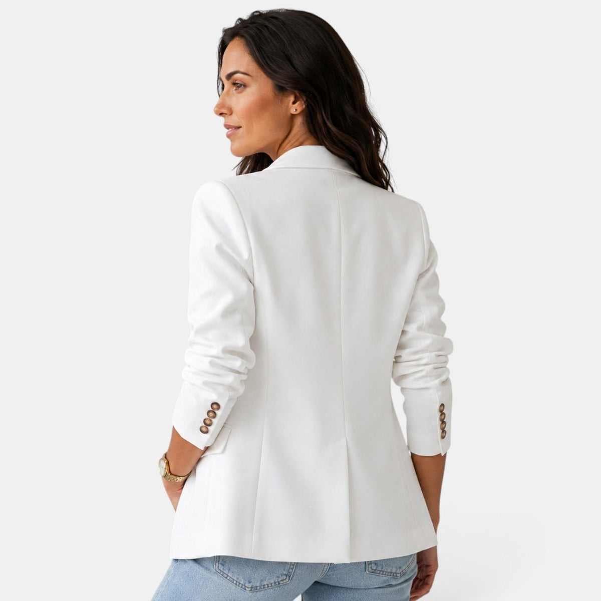 Back view of the white blazer showing the center seam, straight hem, fitted waist, and buttoned sleeve cuffs.