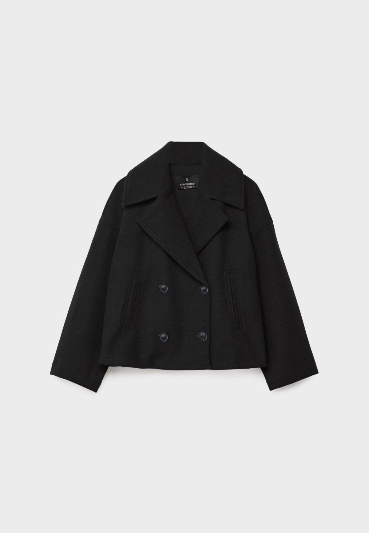Black cropped jacket shown from the front with wide lapels, four buttons, long sleeves, and vertical slanted pockets.