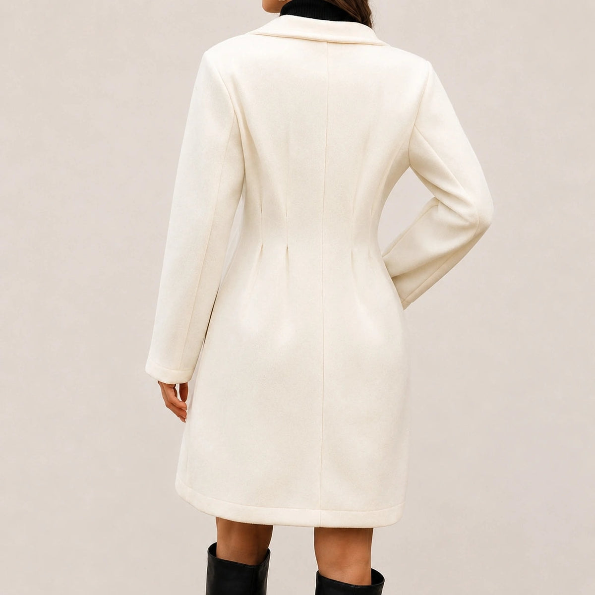 Back view of the ivory knee-length coat, showing the center seam, shaped waist, long sleeves, and straight hem.