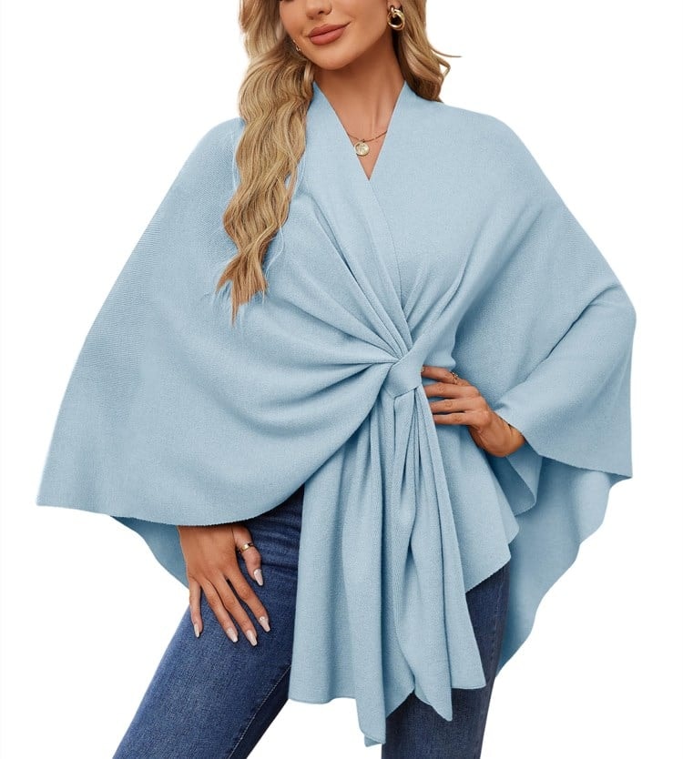 Powder blue poncho wrap with a cinched front and layered asymmetrical hemline.