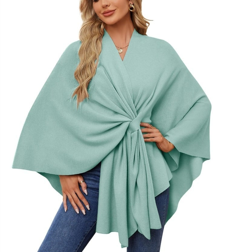 Light mint poncho wrap with a cinched front tie, fluid layers, and broad sleeves.