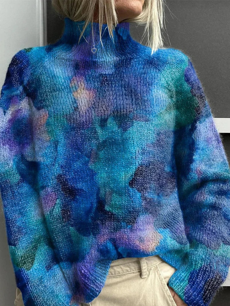 Blue and purple turtleneck sweater with an abstract blended color pattern and long sleeves.