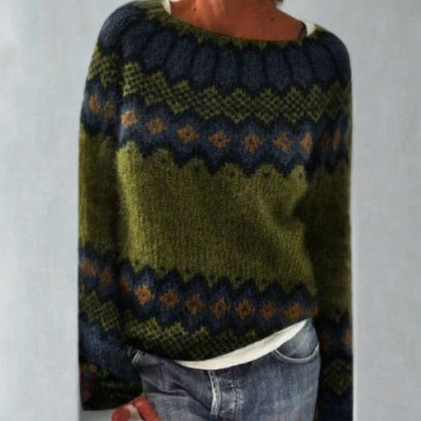 Dark green and navy Fair Isle crew neck sweater with geometric bands and long sleeves, styled with jeans.