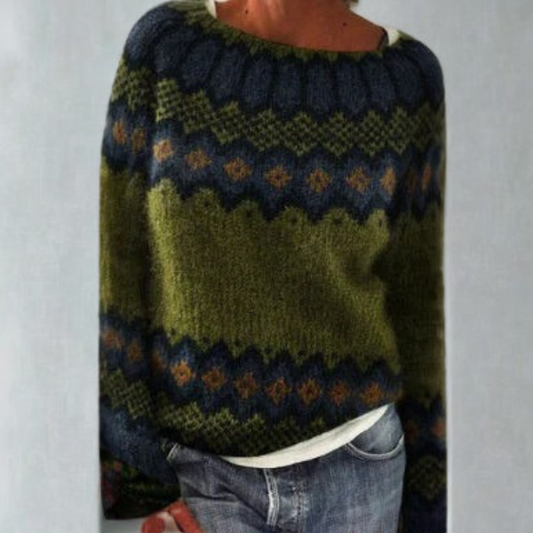 Dark green and navy Fair Isle crew neck sweater with geometric bands and long sleeves, styled with jeans.