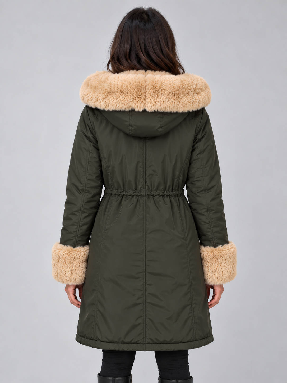 Back view of the dark olive green parka highlighting the faux fur hood trim, gathered waist, long cut, and cuff trim.