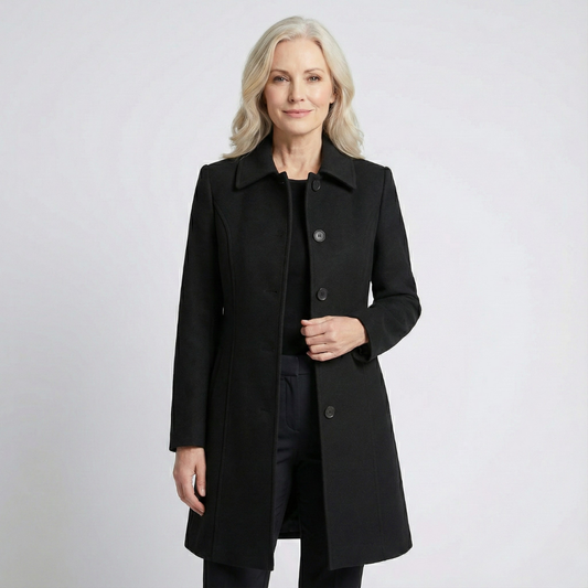 Black fit-and-flare coat with a pointed collar, button-front closure, long sleeves, and above-knee length, worn open.