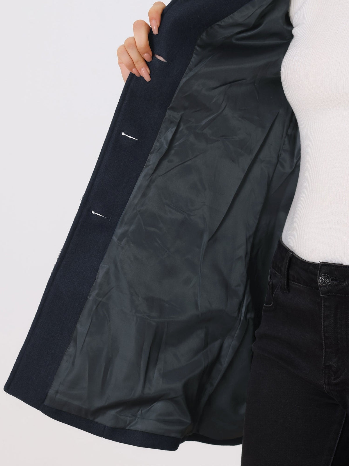 Close view inside the open navy coat, showing the lining and interior side of the button-front closure.