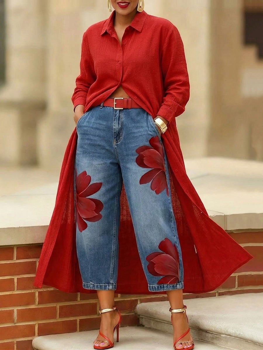 Front view of cropped blue wide-leg jeans showing the high waist, front pockets, and red floral motifs on both legs.