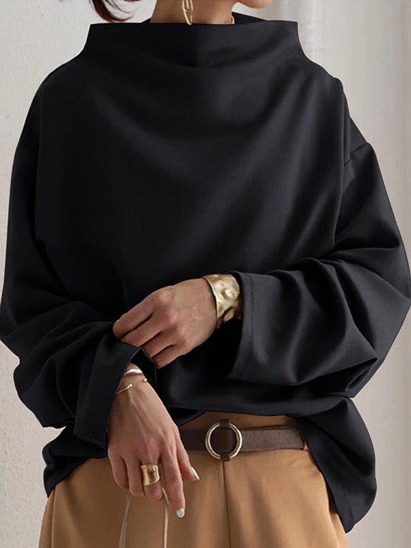 Front detail showing the sweatshirt’s voluminous sleeves gathered at the cuffs and relaxed drape over a belt.