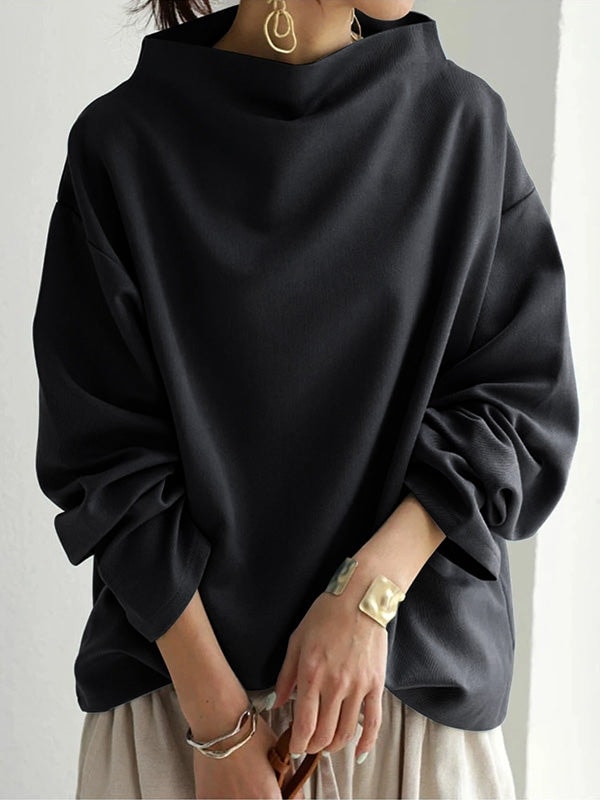 Three-quarter view emphasizing the oversized shape and softly voluminous gathered sleeves.