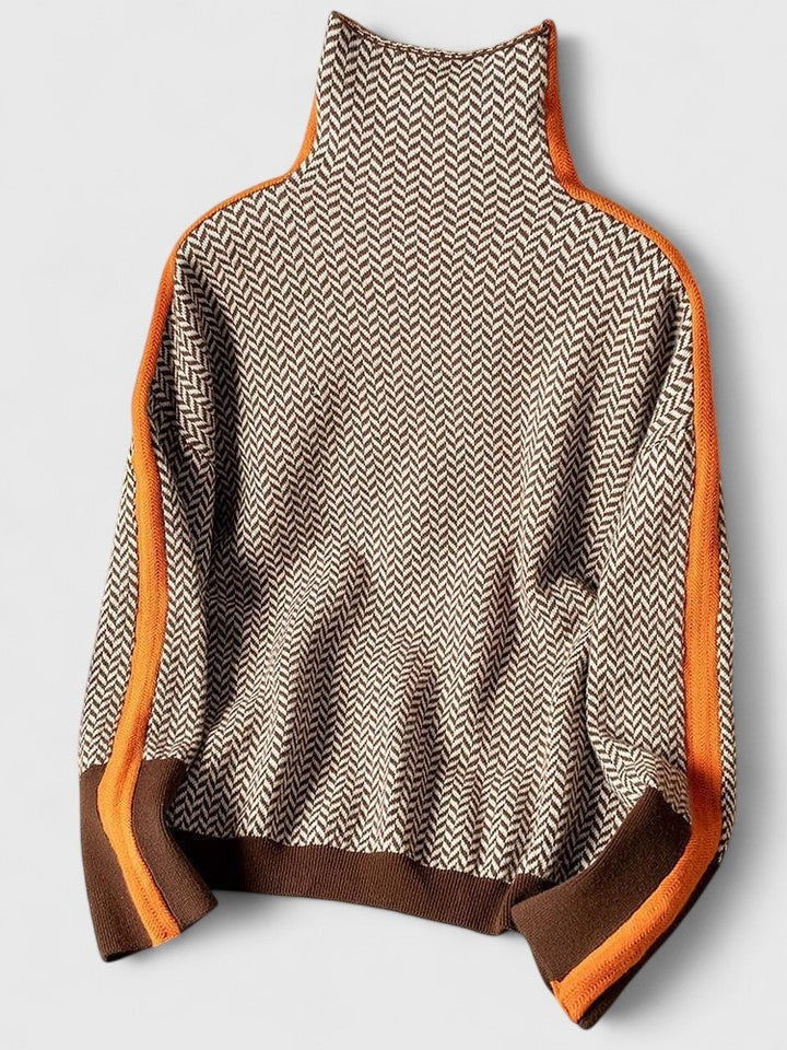 Flat lay of the sweater displaying its high neckline, long sleeves, hip-length shape, and orange-and-brown contrast edging.