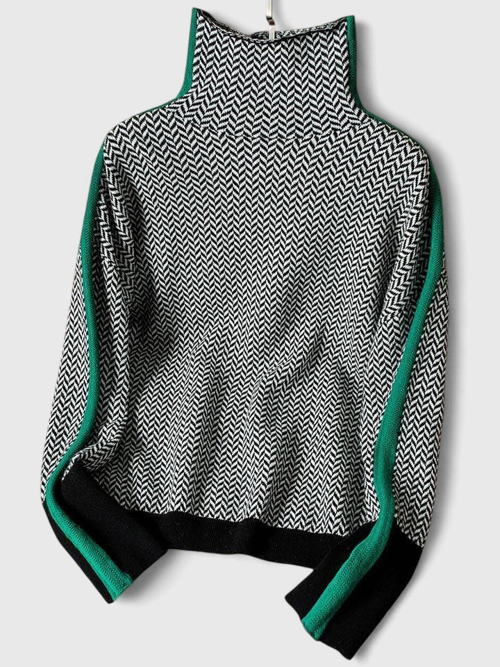 Flat lay showing the sweater’s alternate green-and-black sleeve stripes, high neck, patterned front, and ribbed hem.
