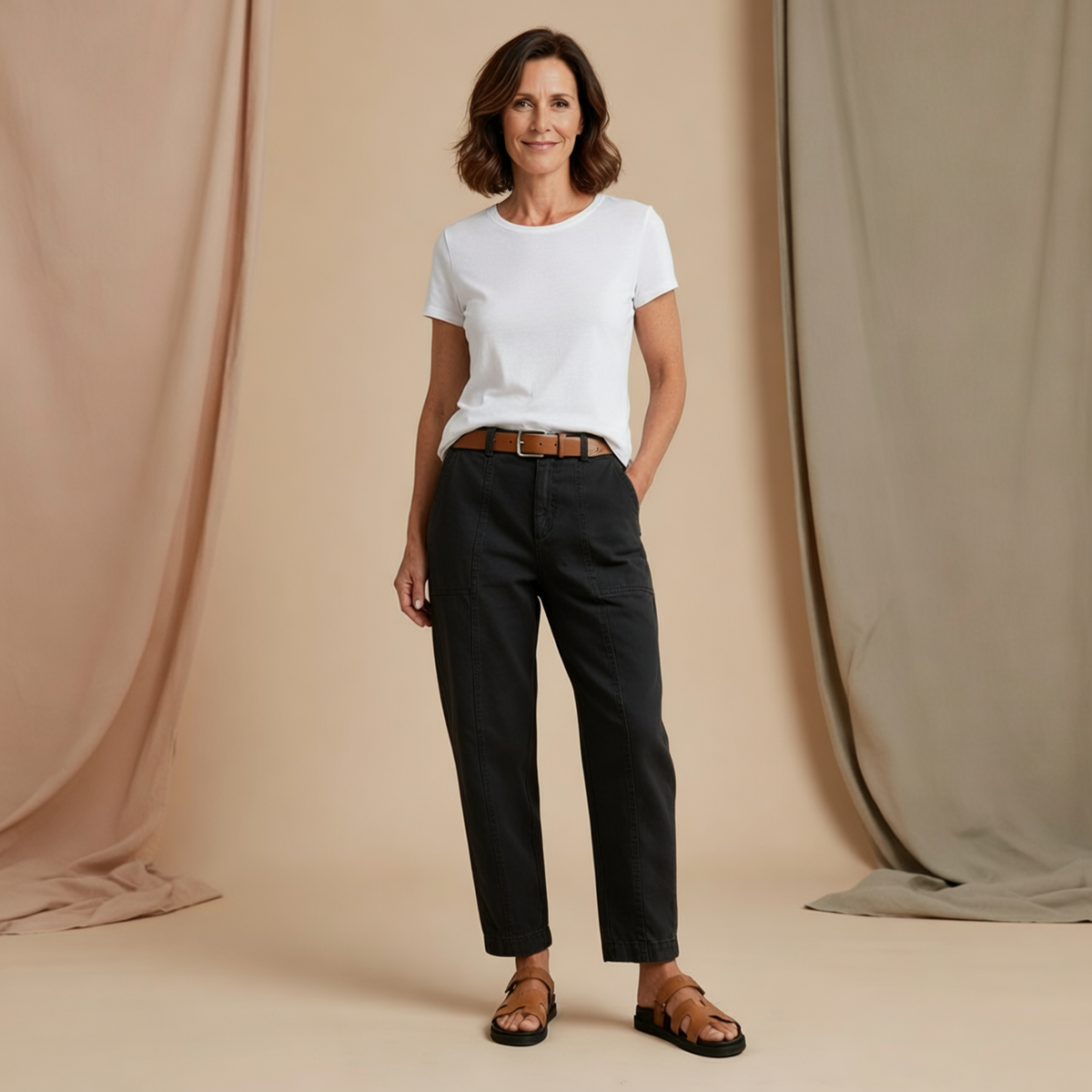 Front view of the high-waist tapered utility pants in black, styled with a white T-shirt and brown belt.