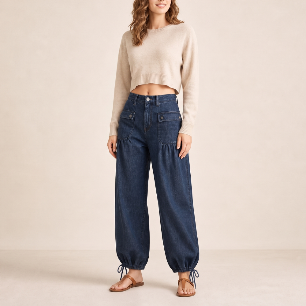 Front full-length view of dark blue high-waisted barrel jeans with cargo pockets and tied ankle hems.