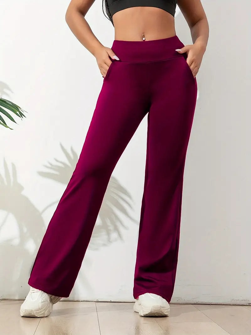 Burgundy high-waisted activewear pants featuring flared legs and a sleek full-length silhouette.
